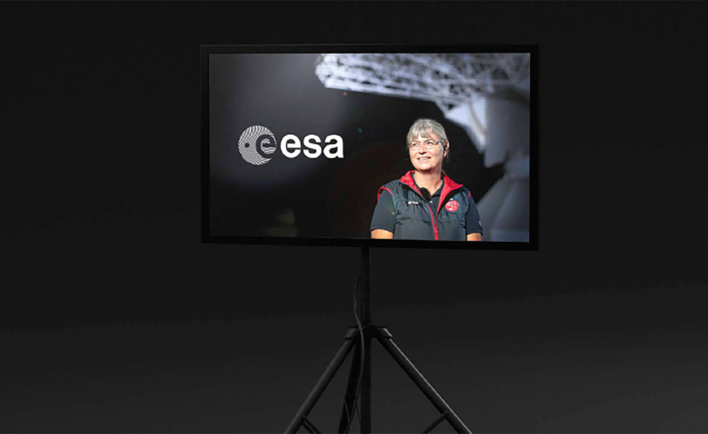 Mock up of ESA logo with staff member pictured in the background